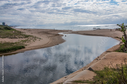 Fototapeta Naklejka Na Ścianę i Meble -  Clouds Reflecting on River Flowing into the Sea