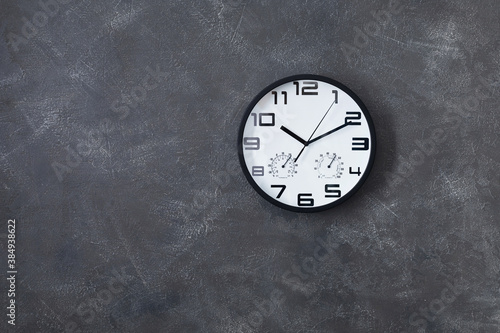wall clock at concrete or painted background