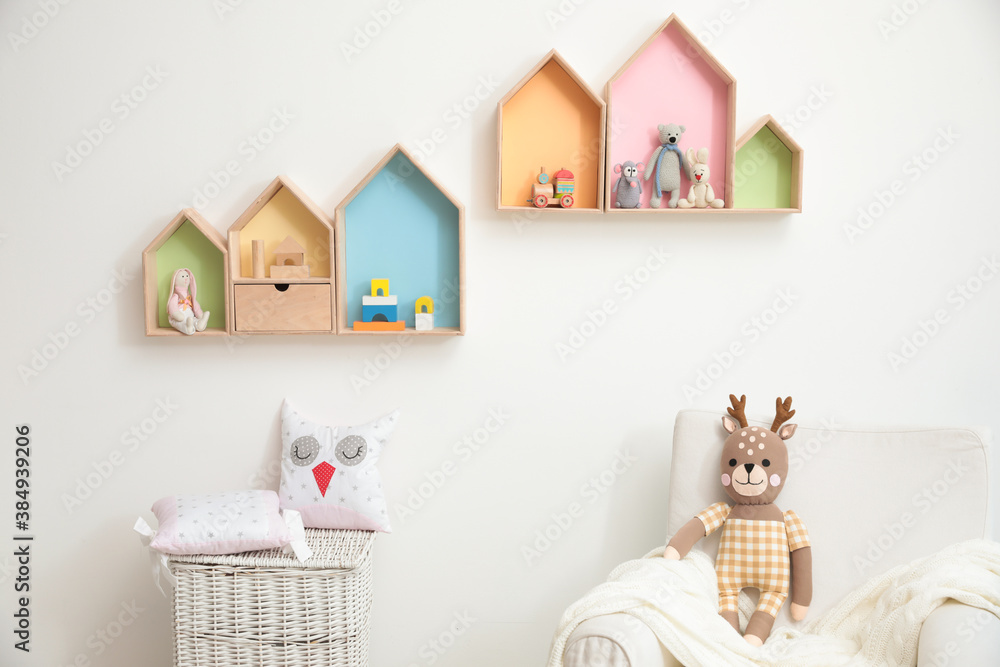 Stylish baby room interior design with house shaped shelves and comfortable armchair - obrazy, fototapety, plakaty 