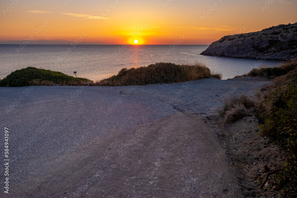 Asphalt road over the Aegean Sea during sunrise