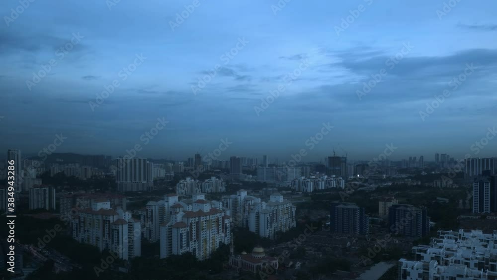 Aerial wide shot of Kuala Lumpur city with skyscarper buildings during cloudy day.Timelapse from dusk to night. Aerial wide shot of Kuala Lumpur city with skyscarper buildings during cloudy day.Timelapse from dusk to night.