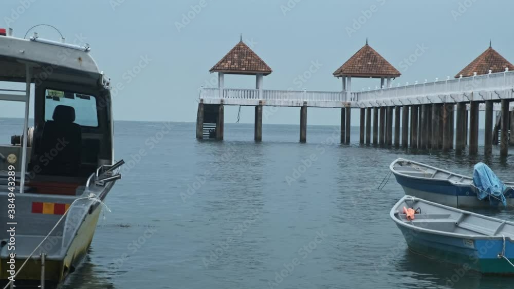Beautiful shot of two boats peacefully floating with a bridge in the background Beautiful shot of two boats peacefully floating with a bridge in the background
