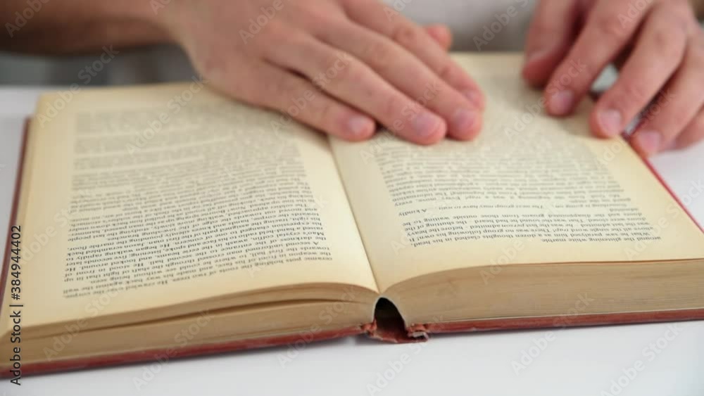 Hand turns book pages. Reading and education concept Hand turns book pages. Reading and education concept
