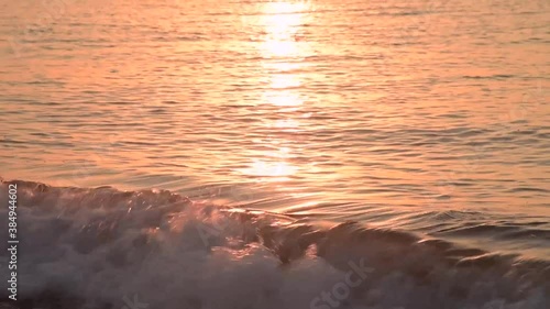 Amazing sunrise over the beach. Yellow golden sun over sea. Orange colors waves. Nature background. Beautiful scene. Morning. Sunlight reflect on water surface