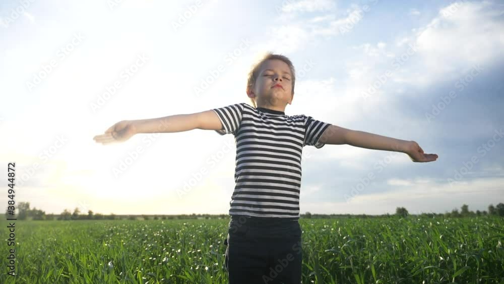 boy prays pulls hands to the sky against a blue sky. child concept faith religion and happy family. kid lifestyle son hands to the side against the blue sky jew praying to god. worship and gratitude boy prays pulls hands to the sky against a blue sky. child concept faith religion and happy family. kid lifestyle son hands to the side against the blue sky jew praying to god. worship and gratitude