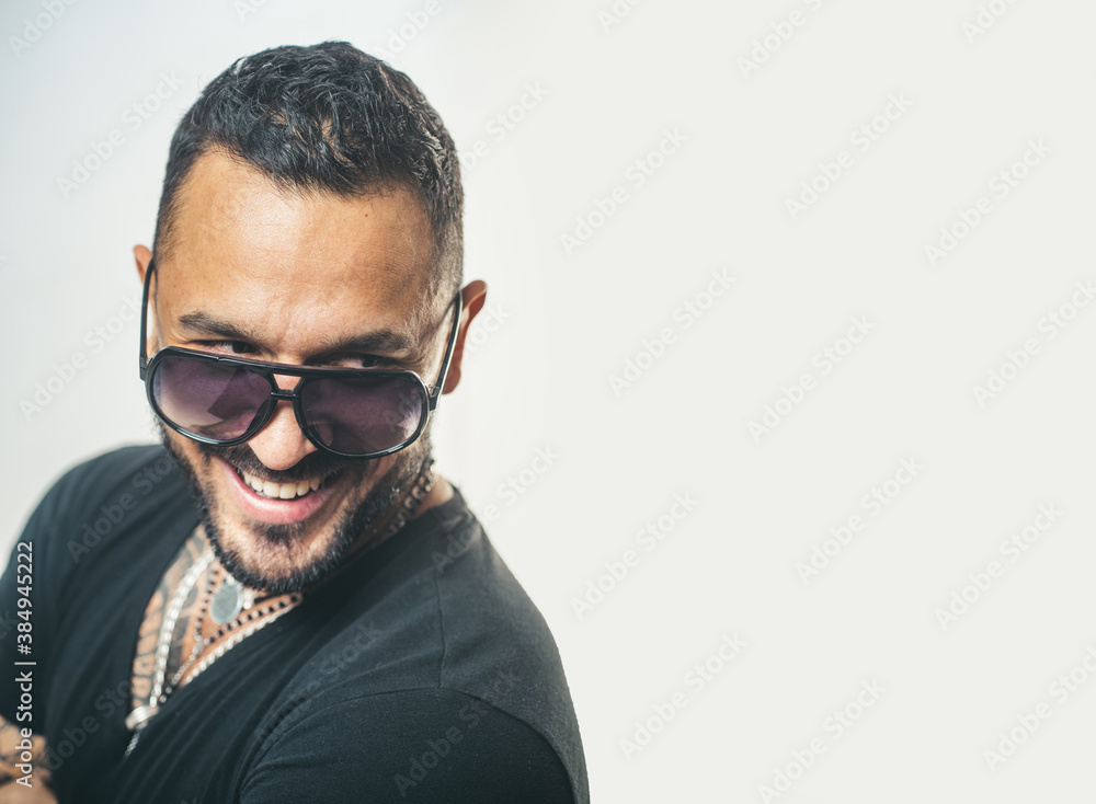 Portrait of stylish happy smiling handsome young man. Fashion guy with sunglasses. Portrait of stylish happy smiling handsome young man. Fashion guy with sunglasses.