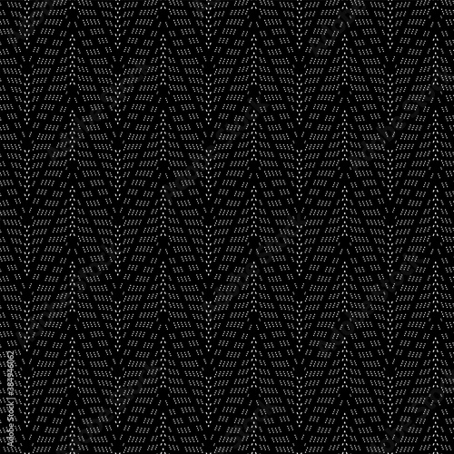 Abstract seamless pattern with white geometric elements on black background.