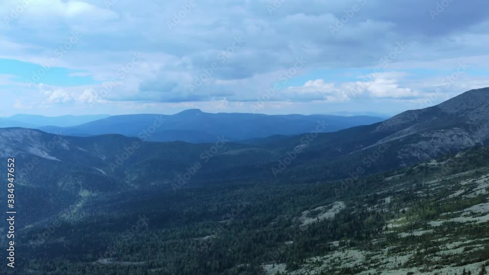 Aerial view from flying drone on mountain forest background and peak of blue mountain range. Aerial view from flying drone on mountain forest background and peak of blue mountain range.