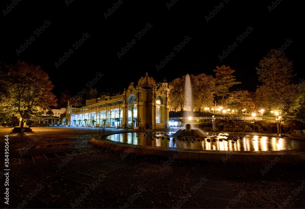 Main cast iron Colonnade and Singing Fountain (atribut of the city) – autumn evening in small Czech spa town Marianske Lazne (Marienbad) – Czech Republic, Europe
