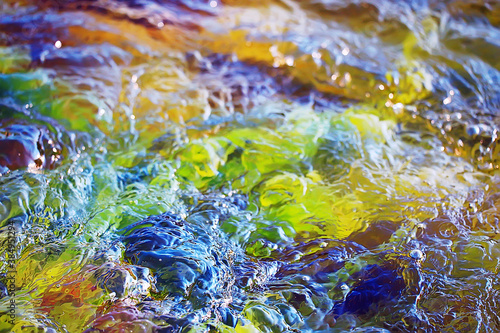Konstfotografi multicolored texture surface of the water stream, clear water, colored stones at