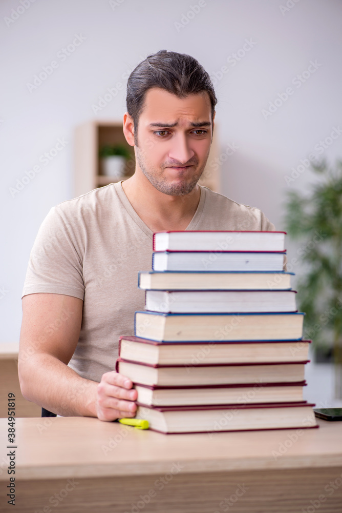 Young male student preparing for exams at library Young male student preparing for exams at library