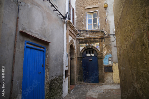 Historic fishing city Essaouira with narrow streets, blue coloured doors of houses © Milan