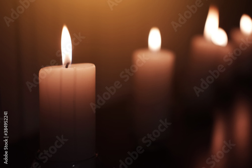 Candle light in Glass cup decoration in spa and christmas night party in Bokeh background. Holiday and Romantic love on valentines day Concept. Prayer and peace in Buddhism