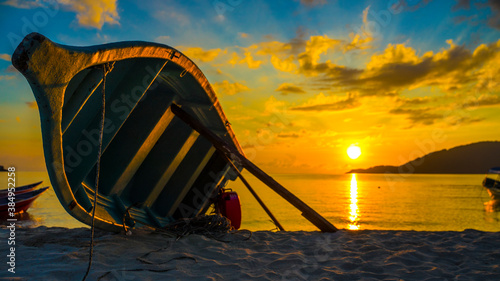 Boat on the beach at sunset, Perhentian Island, Malaysia photo
