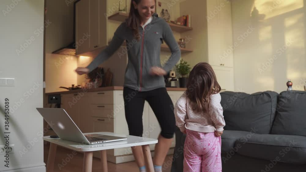 Happy family dancing at home. Mother and daughter having fun together Happy family dancing at home. Mother and daughter having fun together
