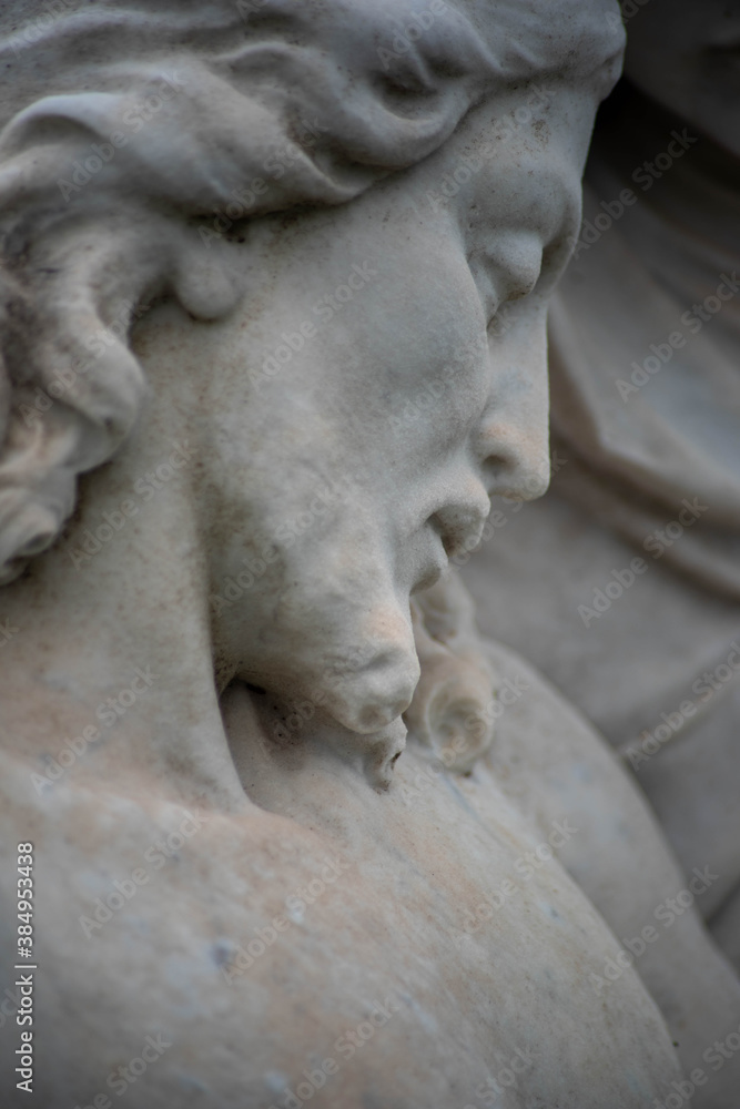 Full frame image of sculpted Jesus face on Victorian cemetery pieta. Selective focus draws the eye toward the facial features. Full frame image of sculpted Jesus face on Victorian cemetery pieta. Selective focus draws the eye toward the facial features.