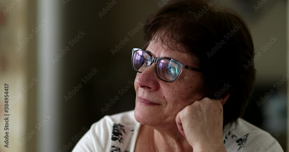 Contemplative older woman portrait staring in daydream Contemplative older woman portrait staring in daydream