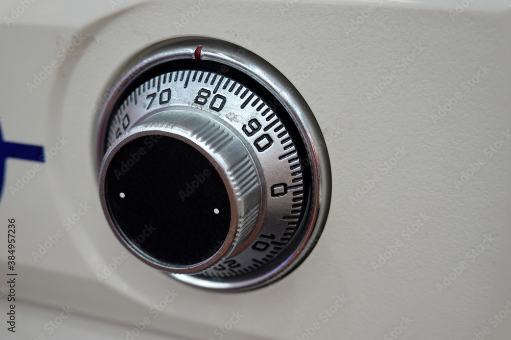 Close-up of a combination dial on a safe. combination lock on the safe closeup white Close-up of a combination dial on a safe. combination lock on the safe closeup white