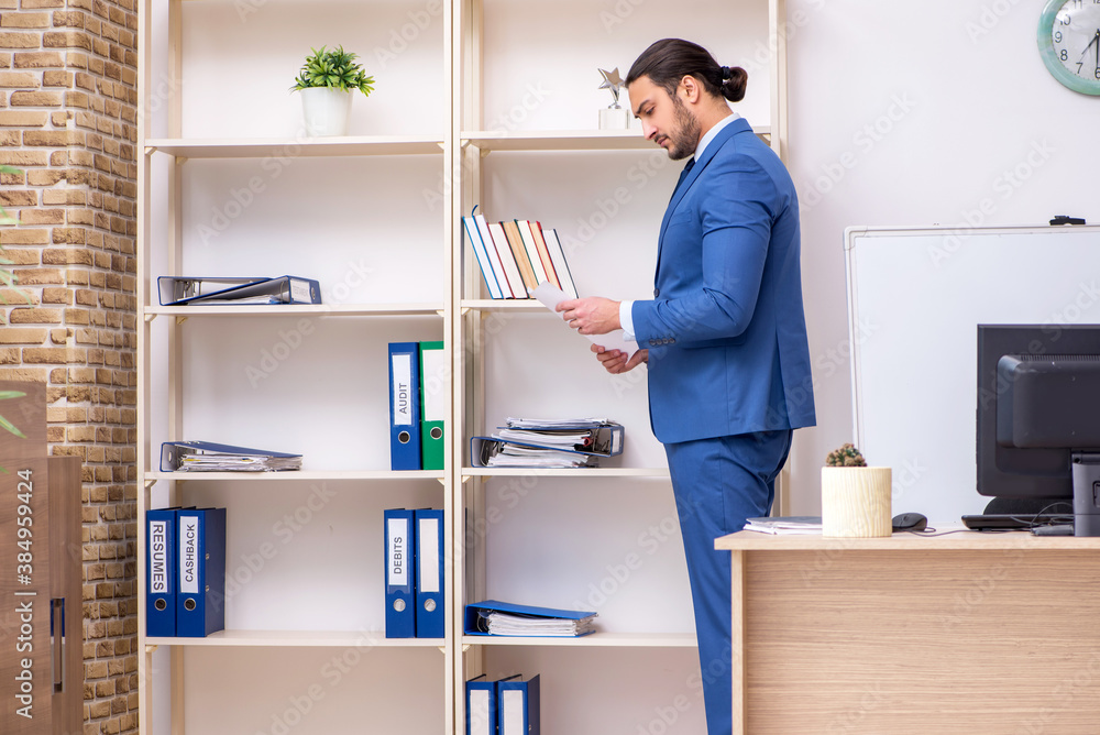 Young male businessman employee working in the office Young male businessman employee working in the office