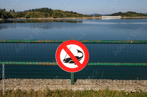 No fishing sign on Giacopiane lake, an artificial reservoir located in the Sturla valley in the municipality of Borzonasca, inland of Chiavari, Genoa province, Italy photo