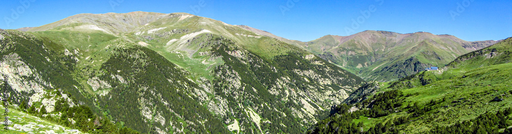 Panoramic of pyrenees mountains in Spain. Vall de Nuria valley in Catalonia during summer with green scenery for hiking and trekking.
