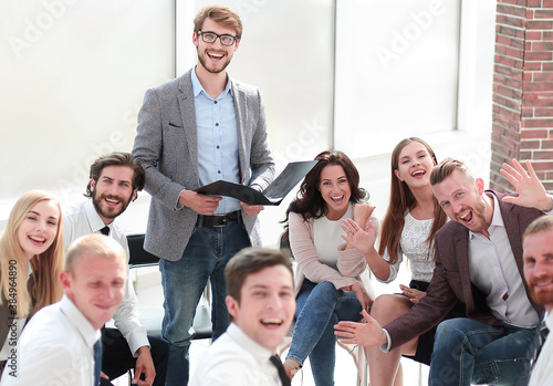 coach and a group of young business people sitting in a conferen