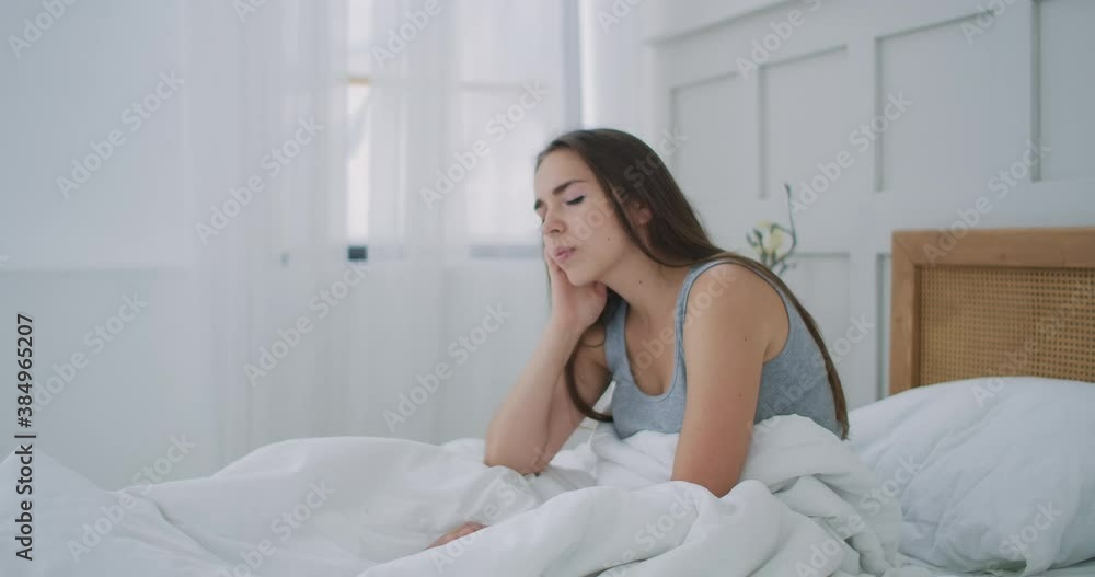 women wake up with a headache, She is stressed and tired, Migraine. A young woman wake up with a headache and a feverish fever. women wake up with a headache, She is stressed and tired, Migraine. A young woman wake up with a headache and a feverish fever.