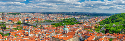 Panorama of Prague city. Aerial panoramic view of Prague Old Town historical centre, Charles Bridge Karluv Most across Vltava river and Mala Strana Town with red tiled roof buildings, Czech Republic