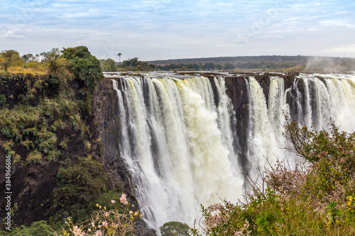 Victoria Falls, a waterfall in southern Africa at the Zambezi River at the border between Zambia and Zimbabwe. Milky water