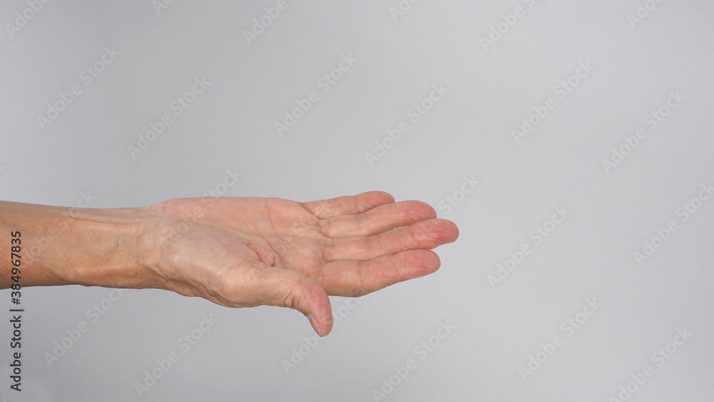 Hand of Asian senior or older woman doing invite on white background.