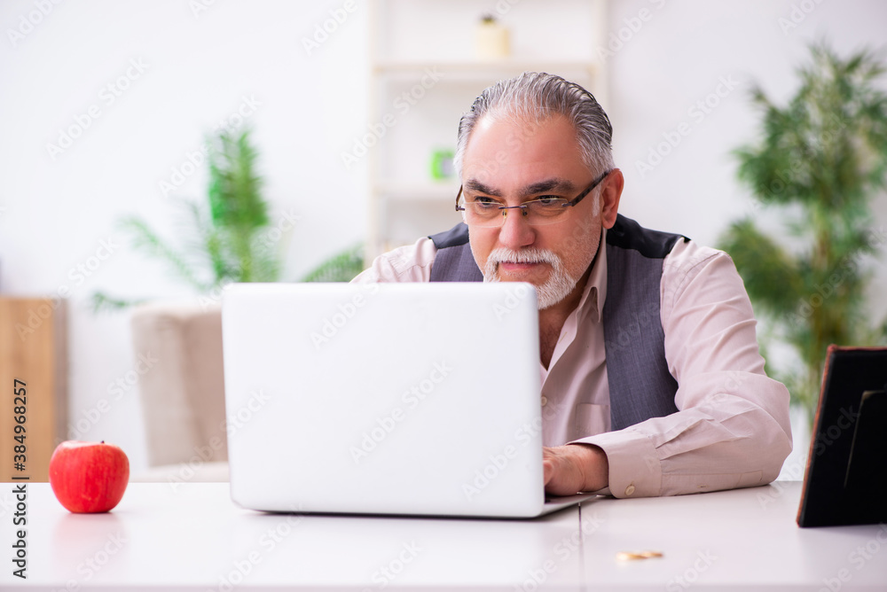 Old man in christmas concept at home Old man in christmas concept at home