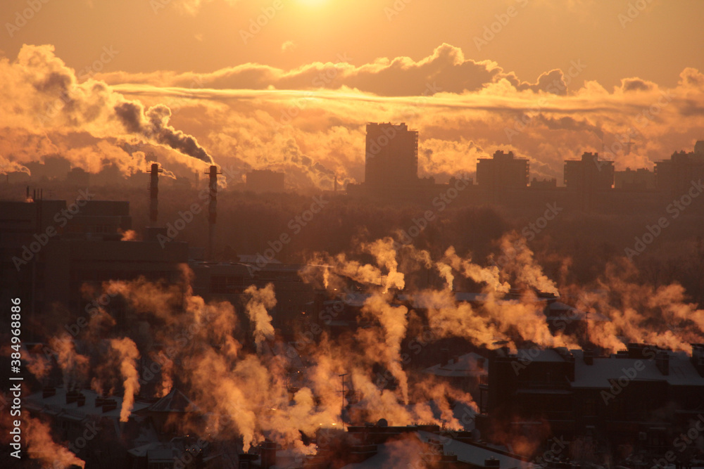 Industrial buildings at sunset and smog. Global warming problem