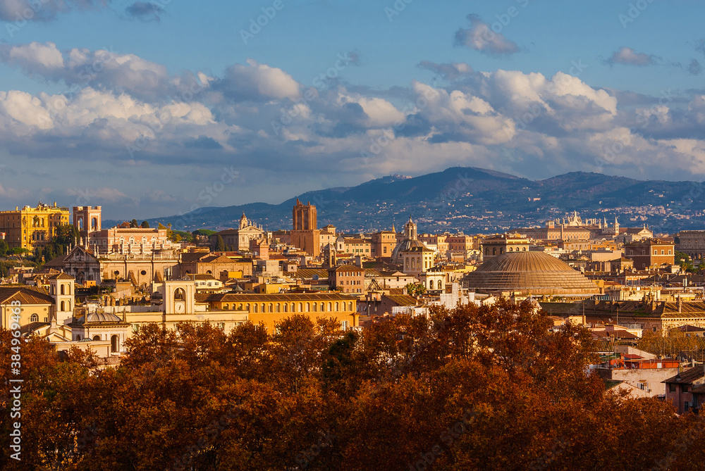 Autumn and foliage in Rome. The city historic center ancient skyline with the famous and iconic Pantheon dome rises above beautiful autumnal leaves