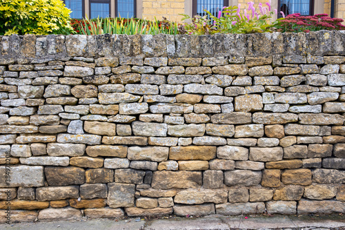 Dry stone wall in front of a house