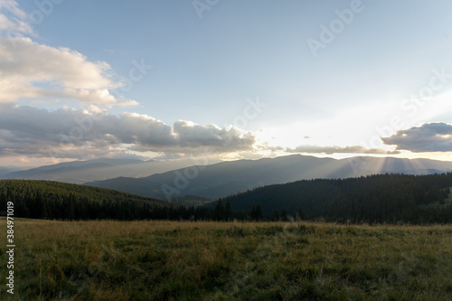 Summer landscape in mountains and the dark blue sky with clouds. Landscape from Bucegi Mountains, part of Southern Carpathians in Romania in a very foggy day