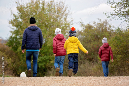 Happy children, running and jumping and playing in autumn colorful park