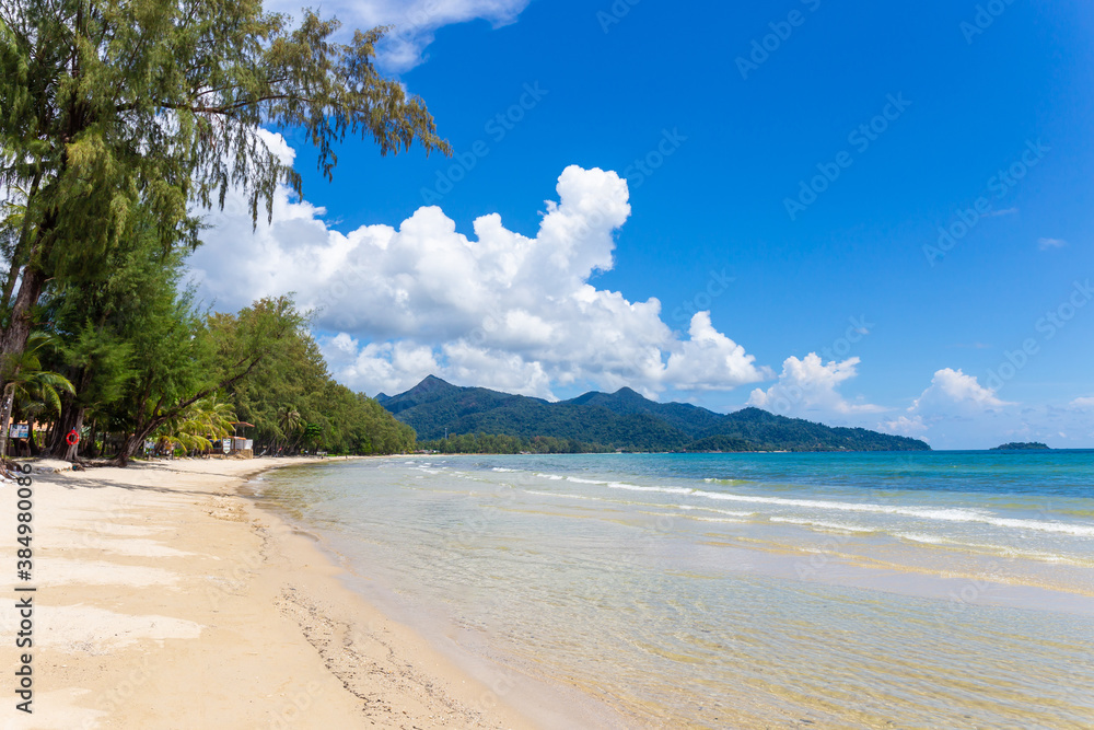A beautiful beach with trees in front of the sea and sky in the background at Koh Chang, Thailand. Copy space background
