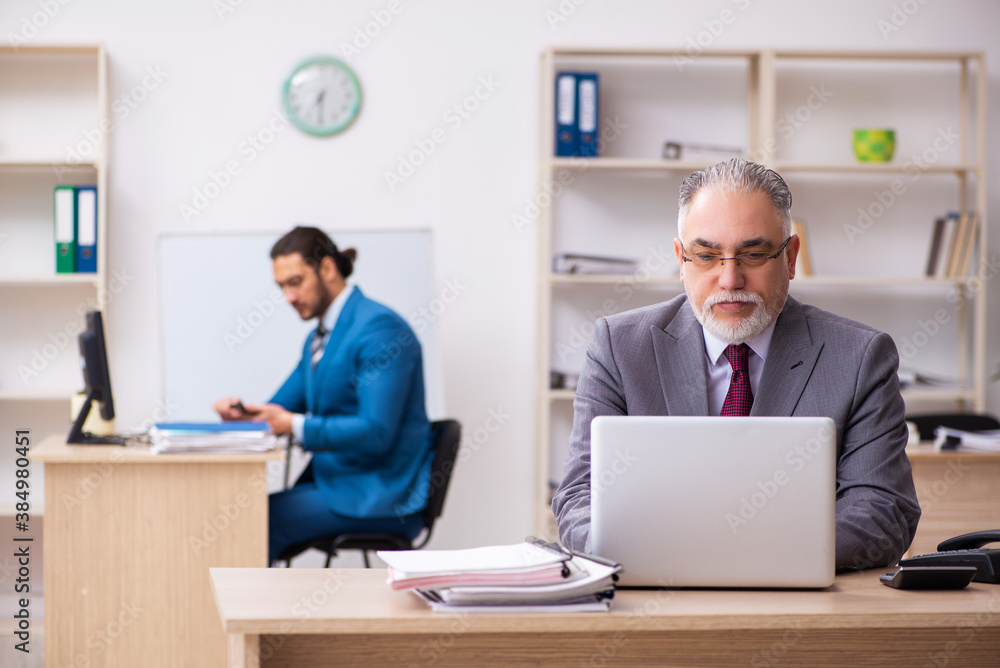 Two male colleagues working in the office Two male colleagues working in the office