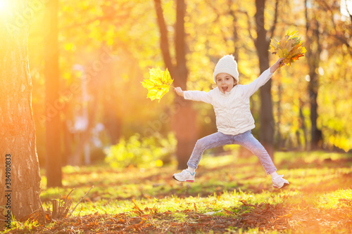 happy girl running in autumn park