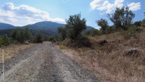 Off road driving down a winding dirt track on a hot summer day