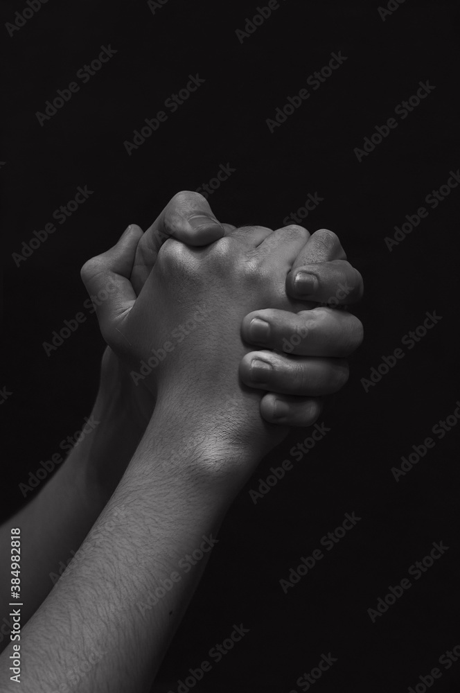 Fototapeta premium men's hands on a dark background close-up