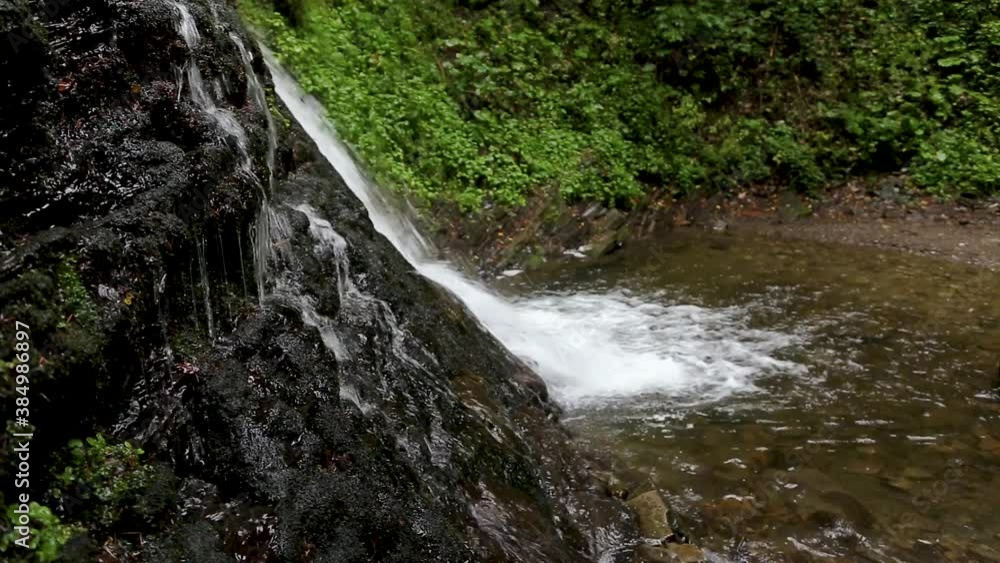 Wonderful waterfall on the mountain river Carpathians. Waterfall, fast mountain water, National Park of Skole Beskydy, Ukraine. Carpathian river, fast current, crystal water, pristine nature. Wonderful waterfall on the mountain river Carpathians. Waterfall, fast mountain water, National Park of Skole Beskydy, Ukraine. Carpathian river, fast current, crystal water, pristine nature.