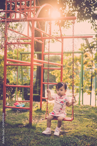 Cute baby in children playground. vintage filter