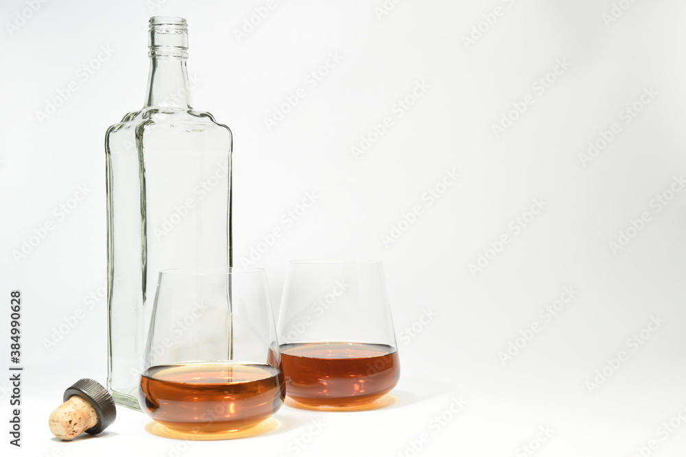 Empty bottle and two filled glasses