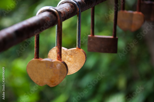 Love lock or Love Padlock hanging on bridge rail with natural background