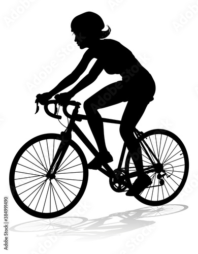 Bicyclist riding their bike and wearing a safety helmet in silhouette