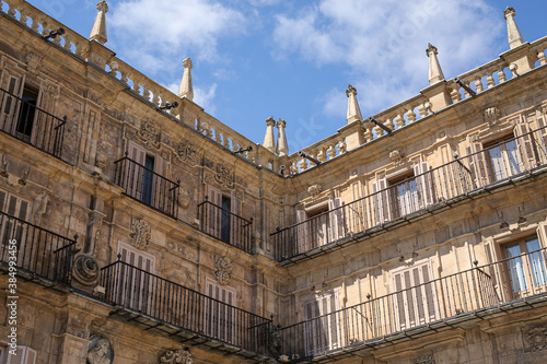 Looking up at the corner of a building in a square in Spain