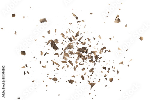 Burned, charred paper scraps isolated on white background, top view