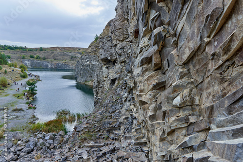 Lake in an ancient quarry with various types of rocks