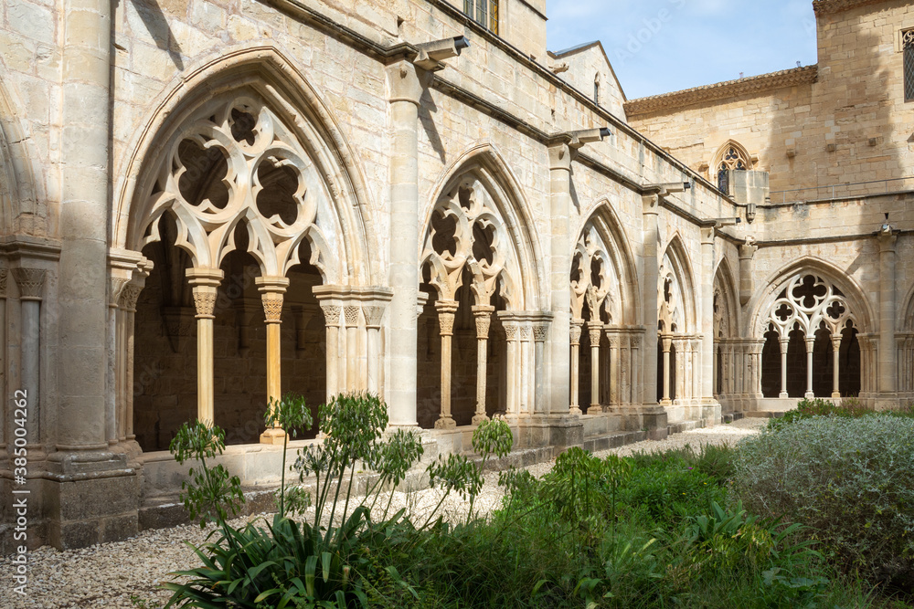 Horizontal view of the Gothic arches from the cloister garden of the Cistercian Monastery of Poblet, Tarragona, Spain, September 24, 2020